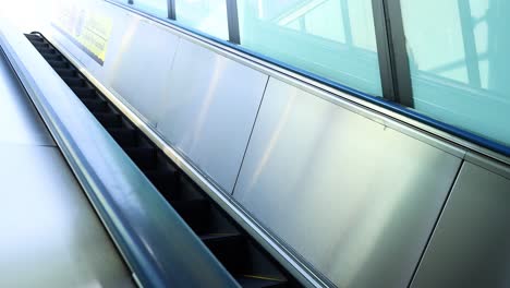 escalator moving in a subway station, no passengers