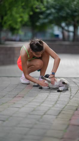 woman caring for a dog in a park