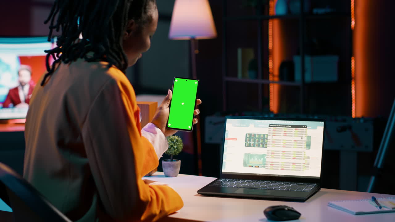 Young woman working with financial spreadsheet and greenscreen