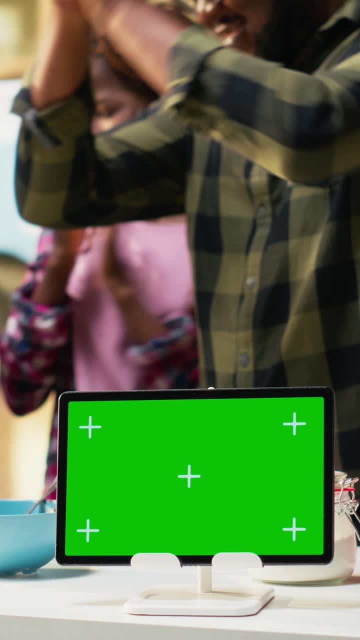 Vertical Video Chroma key on laptop Black parents and kids making homemade pizza