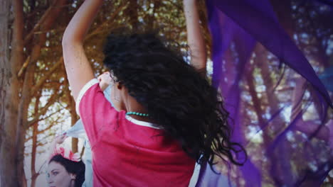 dancing joyfully outdoors, people with colorful lights and trees in background