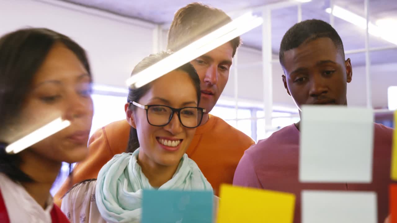 Group of business executives interacting over sticky notes