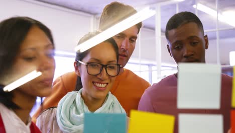 Group of business executives interacting over sticky notes