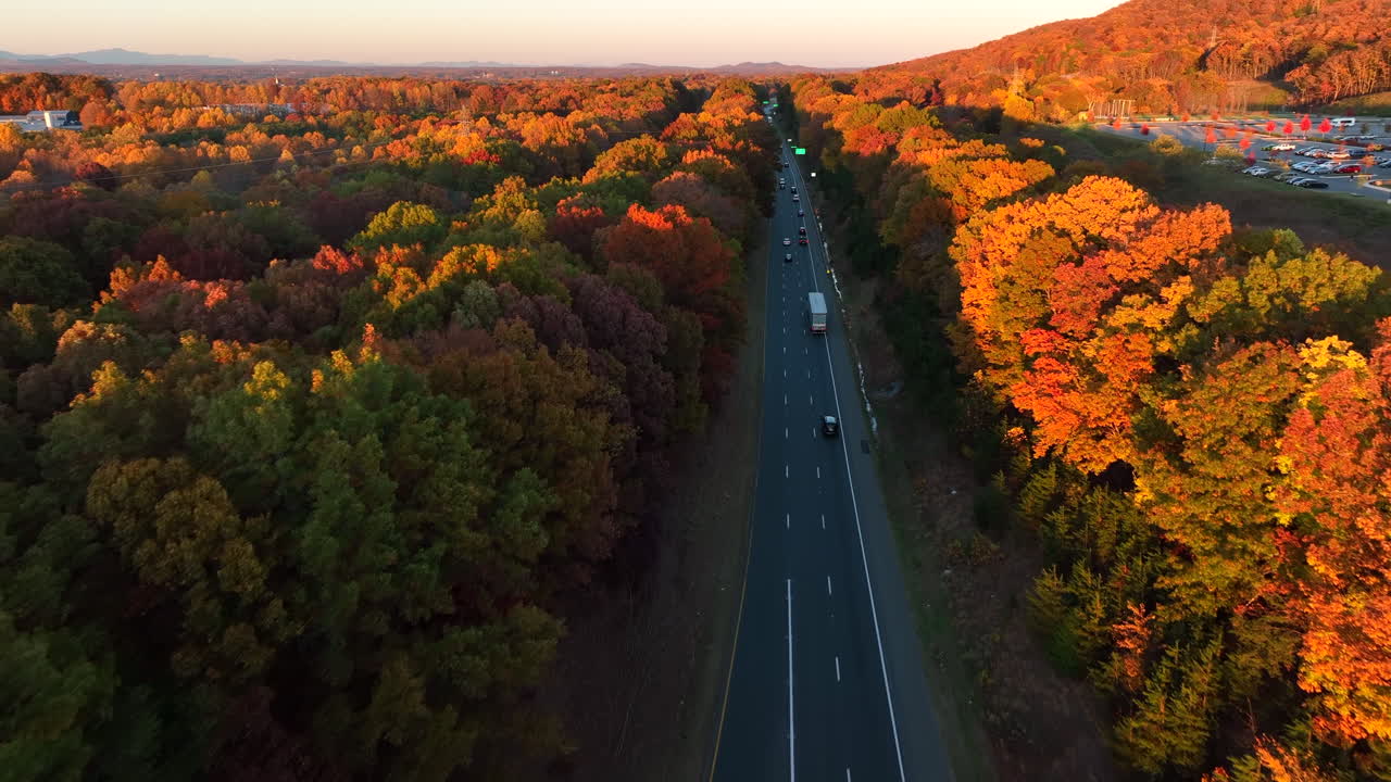 Beautiful aerial flight over highway during autumn fall season