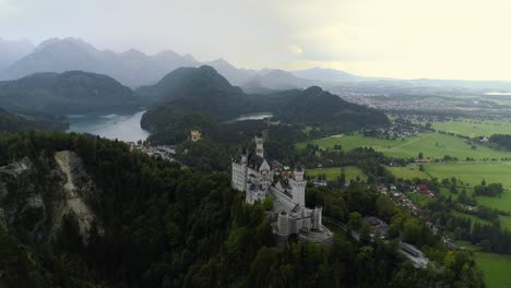 flying onto the famous castle neuschwanstein in bavaria germany sourrounded by the beutiful alps, forrests, landscapes and lake alpsee