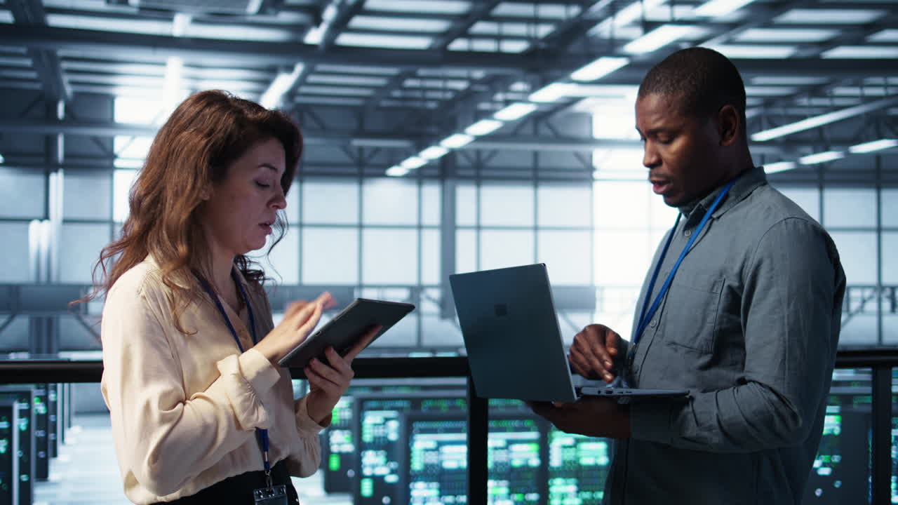 Colleagues in data center workplace use laptop to calibrate energy usage