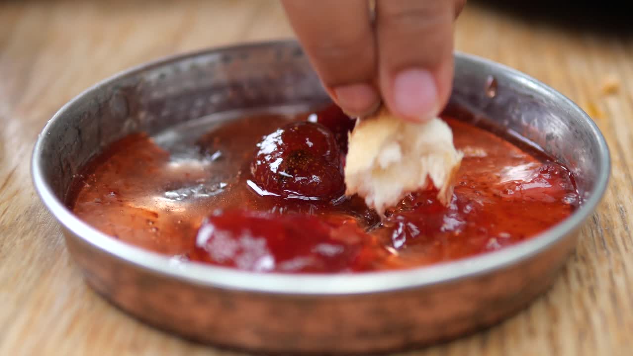 Close up of strawberry jam in a small copper dish