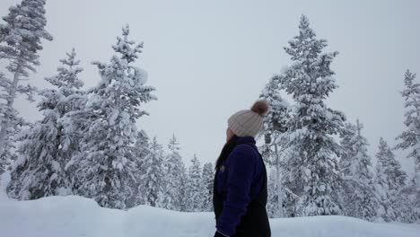 Girl-Takes-A-Stroll-and-Explores-Beautiful-Snow-Covered-Winter-Wonderland-in-Lapland,-Finland,-Arctic-Circle