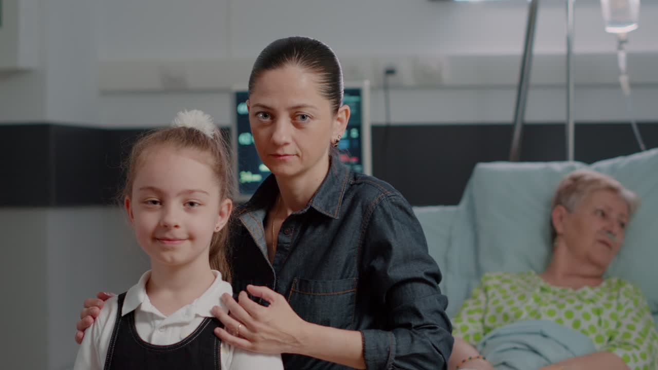 Portrait of woman with young child sitting in hospital ward