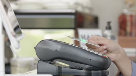 customer using credit card scanning for make online payment at cafe