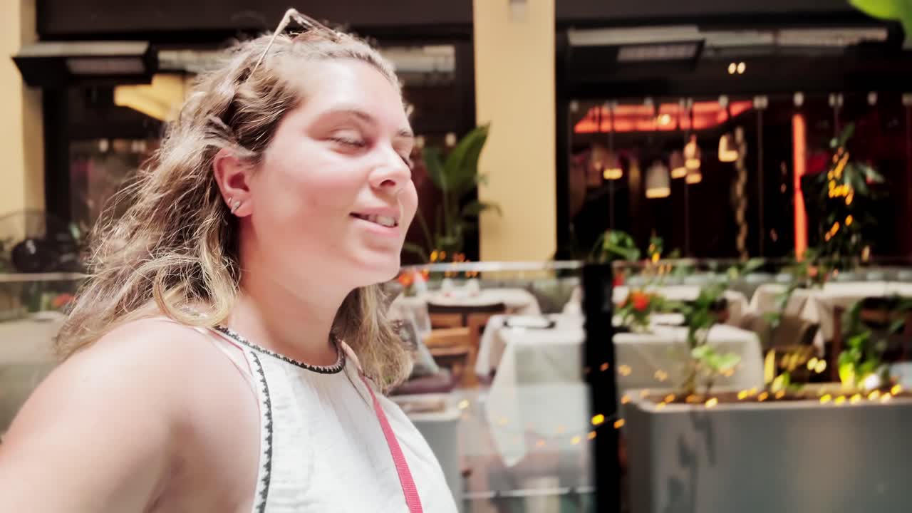 Young Woman Vlogging or Taking Selfie in Urban Mall Environment