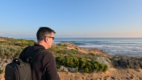 man photographing coastal scenery in melbourne, australia