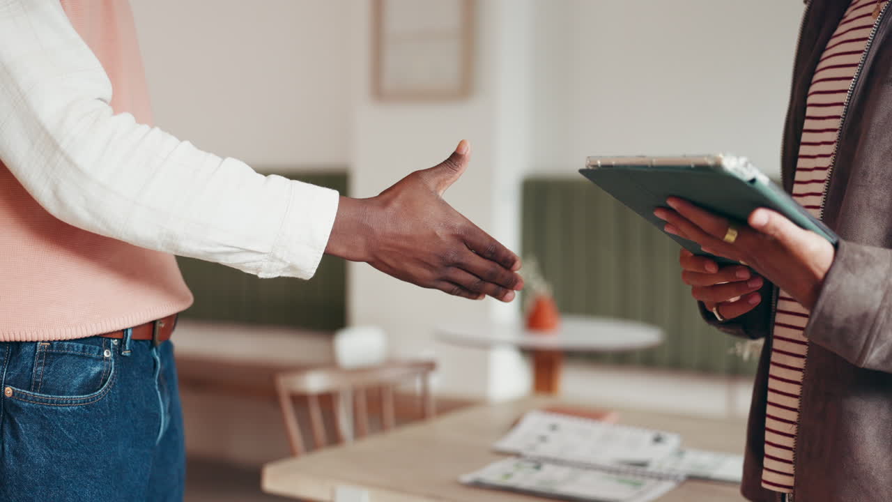 Two people shaking hands in a business setting
