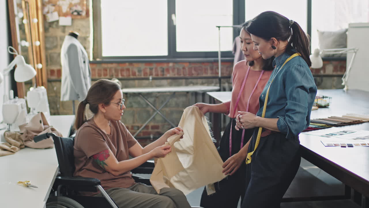 Female Fashion Designers Chatting with Seamstress