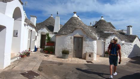 Traditionnal-houses-of-the-heritage-site-of-Alberobello-and-a-young-man