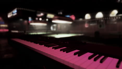 a piano in a dark bar with a pool table in the background