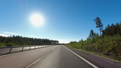 hyperlapse pov: driving on country highway, sun ball in blue sky