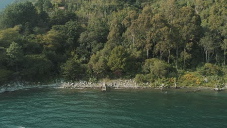 Vista-Aérea-De-Drones,-Volando-Lejos-Del-Muelle-Del-Hermoso-Lago-Atitlan,-Guatemala