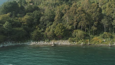 drone aerial view, flying away from the dock of beautiful lake atitlan, guatemala