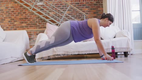 caucasian vlogger female exercising at home