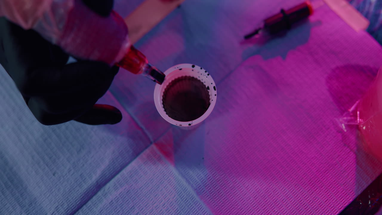 Tattooing process with ink in cup