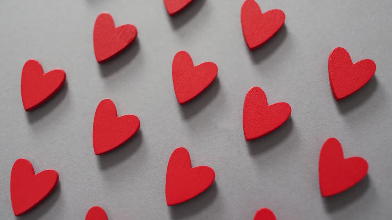 Red wooden hearts on gray background at valentine's day