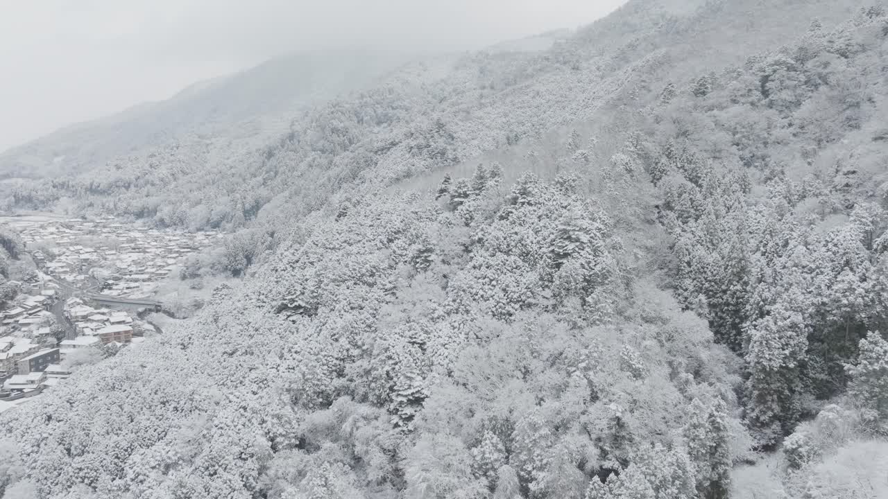 Aerial Drone fly Snowed Residential Streets in Kyoto Japan, Mountain Valley landscape