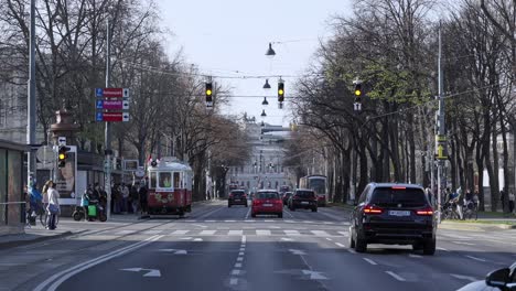 busy street scene in vienna with traffic, a tram, and pedestrians
