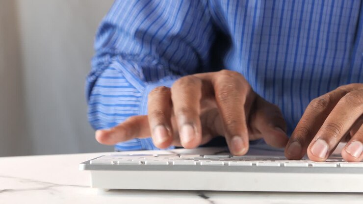 Person typing on a computer keyboard
