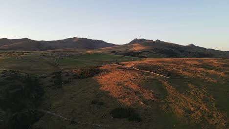 aerial drone shot of the alps while sunset with huts and farmland, beautiful nature