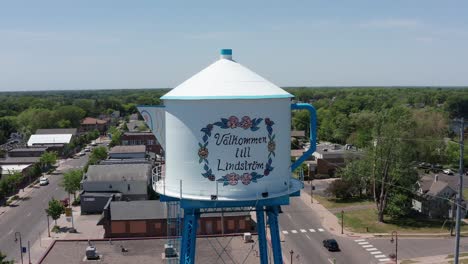 Parallax-panning-close-up-aerial-shot-of-the-Swedish-Coffee-Pot-Water-Tower-in-Lindstrom,-Minnesota