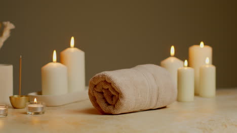 Still-Life-Of-Lit-Candles-With-Dried-Grasses-Incense-Stick-And-Soft-Towels-As-Part-Of-Relaxing-Spa-Day-Decor-2