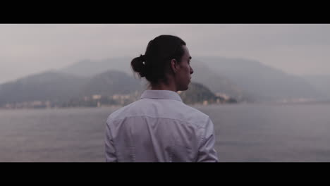 man looking at lake view