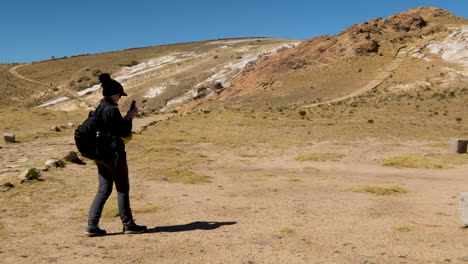watch a tourist capturing the historical ceremony table on isla del sol, copacabana, bolivia, with their camera