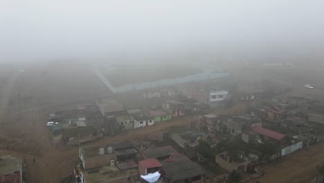 misty drone shot of poor neighborhood flores de villa in the district of san juan de miraflores in lima, peru