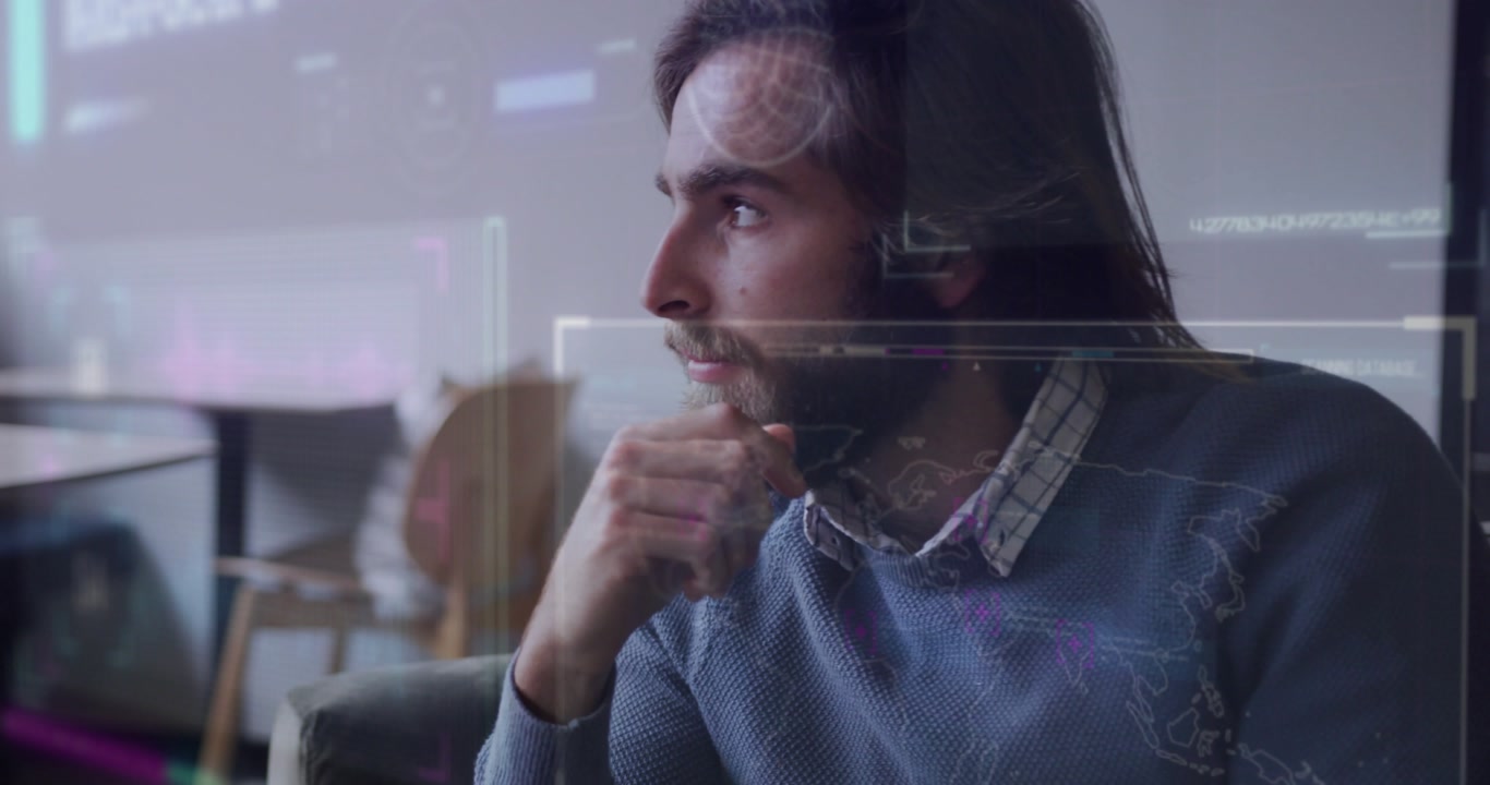 Vertical video: Reacting to HUD, man in blue knit sweater studying overlays on sofa, copy space