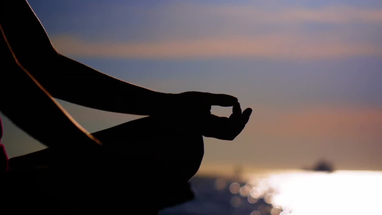mujer realizando yoga en la playa