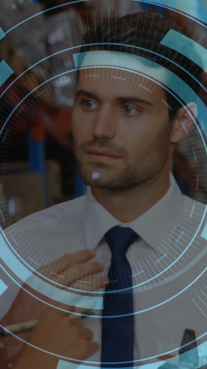 Vertical video: Manager in warehouse getting staff hand pen fixing tie while HUD growing over torso