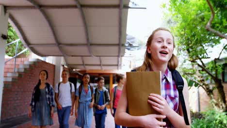 Schoolgirl-waving-hand-while-walking-4k