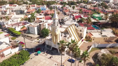 Jib-up-of-people-standing-in-front-of-small-church