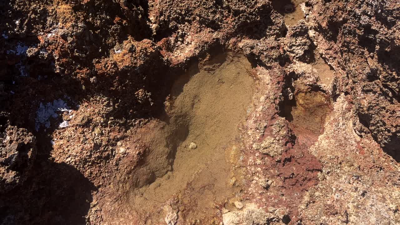 Close up of eroded rocky surface with small water pools in Crete Greece