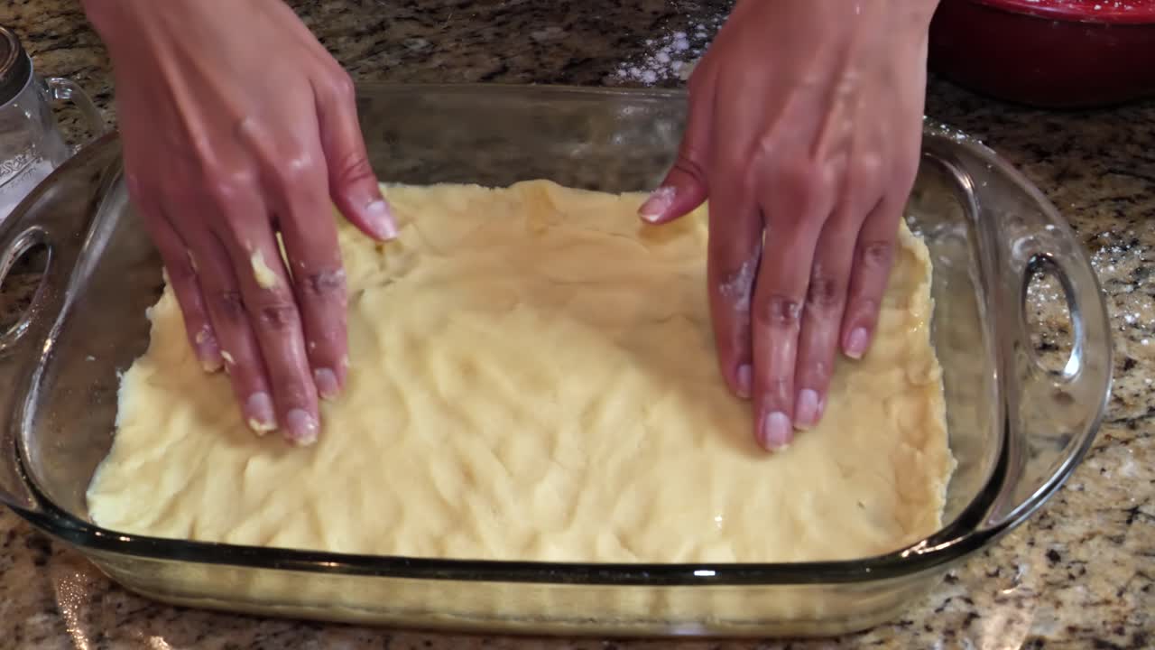 Hands closeup making preparing shortbread crust pastry in glass bowl