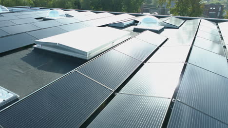 drone view flying over solar panels in the sun on an industrial roof
