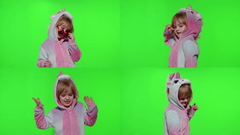 Child-girl-in-unicorn-pajamas-making-silly-funny-faces,-fooling-around,-showing-tongue-on-chroma-key