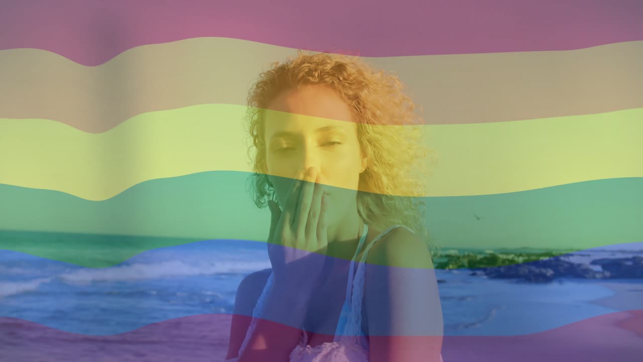 Business creator starting filming woman walking sunlit beach brushing cheek and sending heart icons