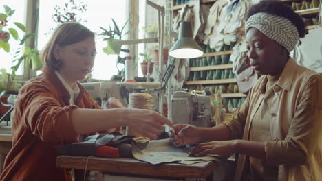 multiethnic women working in shoemaking workshop