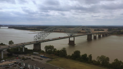 aerial tracking shot of the hernando de soto bridge in memphis tennessee looking back at west memphis, arkansas