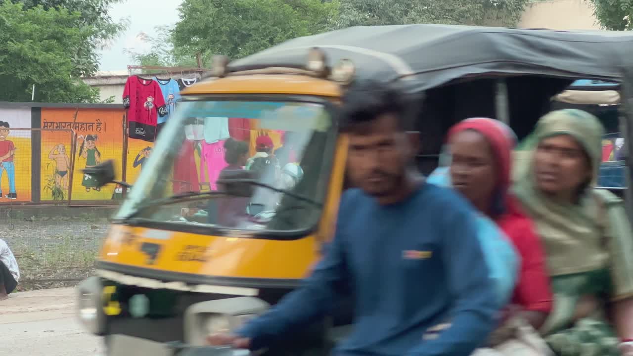 People buying t-shirts and other cloths from street shops in India