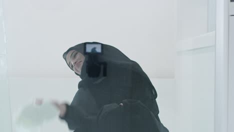 young arabian muslim woman in traditional hijab clothes praying on the glass floor