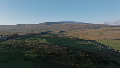 wide angle drone shot of ribblehead viaduct and snowy whernside uk